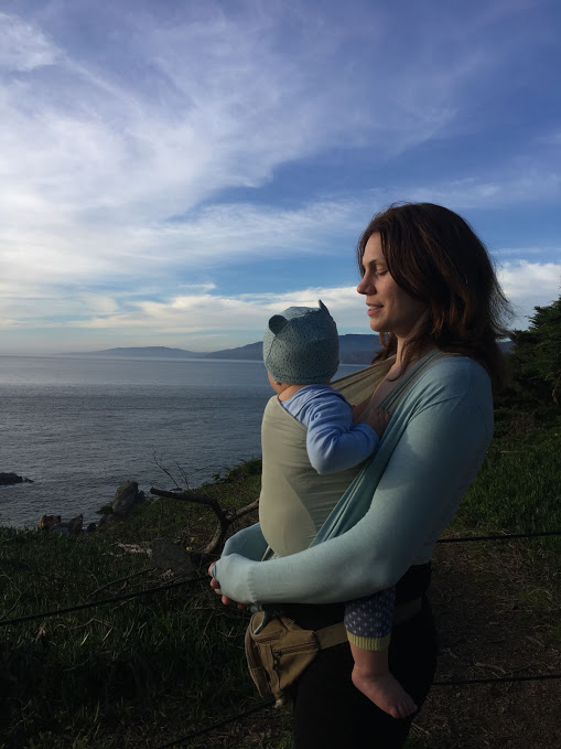Mother wears baby in sling